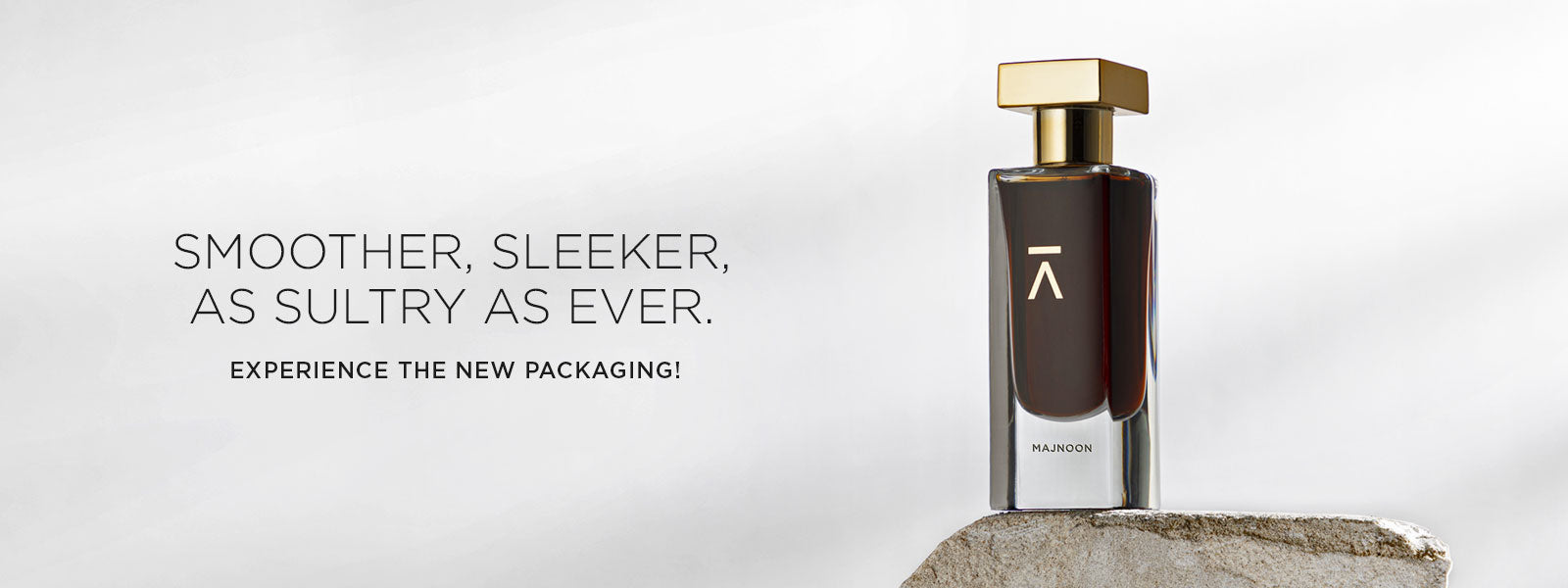 Azman perfumes has cerated Majnoon perfumes in collaboration with famous perfumer Prin Lomros. Majnoon is made of pomegranate, coffee, rose, jasmine and two types of different ouds. For Majnoon we used long neck hand polished bottle and heavy gold metal cap. We have have used heavy black box with side opening. Box has gold foil Azman logo. Azman Majnoon bottle shot in grey color studio background. Bottle is sitting on rock to give rough and edgy look and feel.
