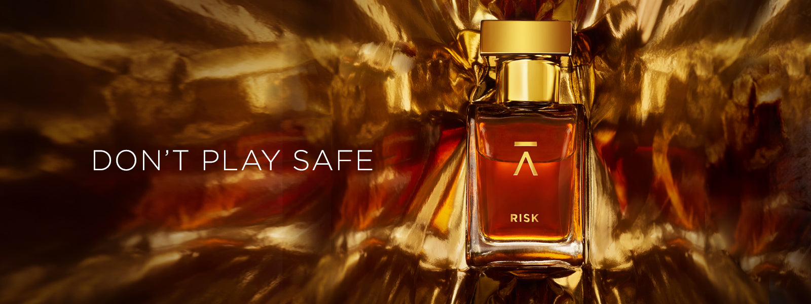 Azman Risk Perfume collaboration with Italian perfumer Antonio Gardoni. Majnoon bottle features a long neck, hand-polished bottle with a heavy gold metal cap. The packaging includes a side-opening heavy cardboard box adorned with a gold foil Azman logo.  Azman Risk perfume bottle is shot in dramatic gold foil to gives ultra stylish effect. The whisky gold color of the Risk perfume adds a touch of luxury and sophistication.