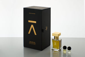 Azman Perfumes Special Edition, crafted by the award-winning Zoologist Bee Perfumer Cristiano Canali. Studio-shot perfume bottle dark background, showcasing warm green liquid. The 30ml, slender bottle features a runway model like long neck, adorned with a luxurious heavy gold metallic cap, enhancing the allure of the presentation and the perfume's name. Perfume also comes with cute little 1g oil vials of Mysore Sandalwood oil and Turkish Rose oil.