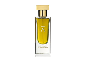 Azman Perfumes, crafted by the award-winning Zoologist Bee Perfumer Cristiano Canali. Studio-shot perfume bottle against a crisp white background, showcasing warm green liquid. The tall, slender bottle features a runway model like long neck, adorned with a luxurious heavy gold metallic cap, enhancing the allure of the presentation and the perfume's name.