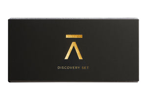 Image description: Azman Perfumes new discovery set photographed against a white background. The set features 8 fragrances, including the new Risk by Antonio Gardoni. The black hard box packaging has a flat opening and is adorned with a gold foil "A" from Azman and elegant lettering.