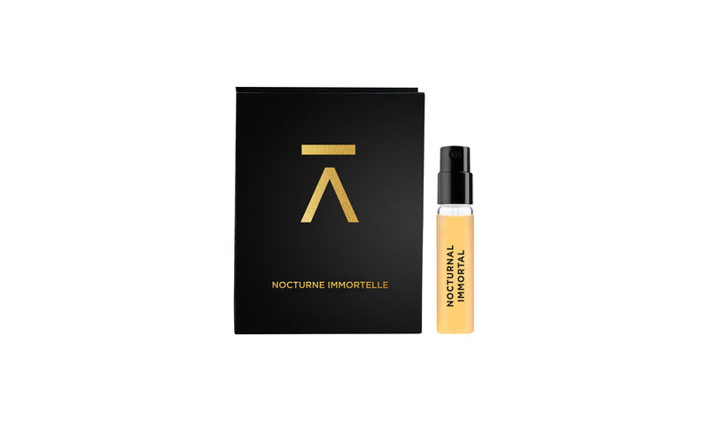Studio photograph of the ‘Nocturnal Immortal’ 2ml sample with sleeve by Azman Perfumes, created in collaboration with Julien Rasquinet. Set against a white background, the sample reflects a woody, oriental, and mysterious aesthetic. The perfume features key notes of Fir Balsam Absolute, Orange Bitter Oil, Cistus Labdanum, Vetiver Oil Haiti, and Hay Absolute, embodying a rich and natural essence.